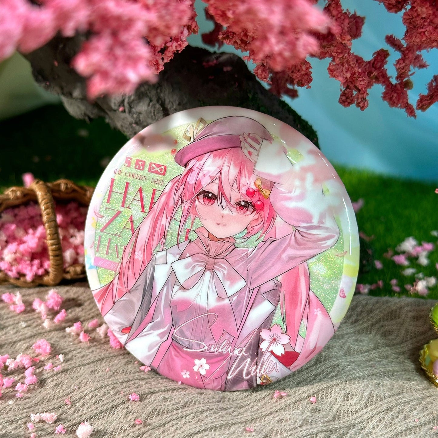 Large 75mm Sakura Miku round badge with pearlescent shimmer base and pink glitter finish, aesthetic Vocaloid fan art pin.