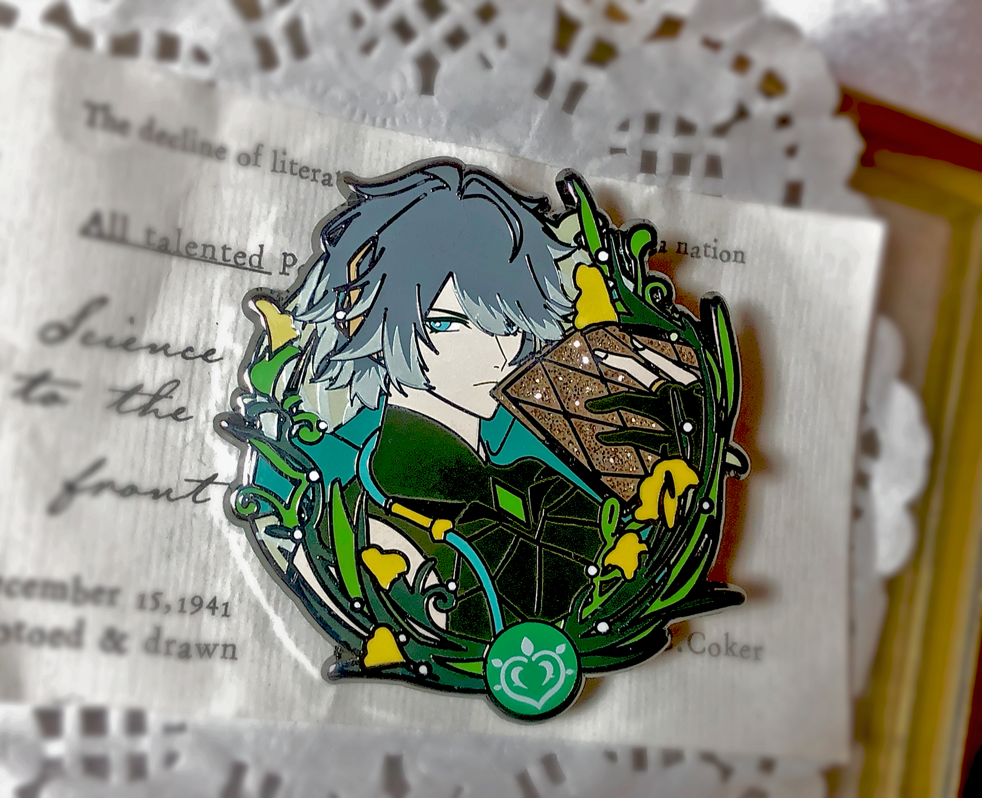 Detailed Alhaitham enamel pin with green glitter accents and polished silver-tone metal outlines, Genshin Impact aesthetic lapel pin by AO Treehouse.