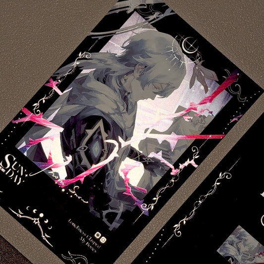 Angled view of Sunday art print card showing intense red metallic foil reflection on the ornamental frame under low light.