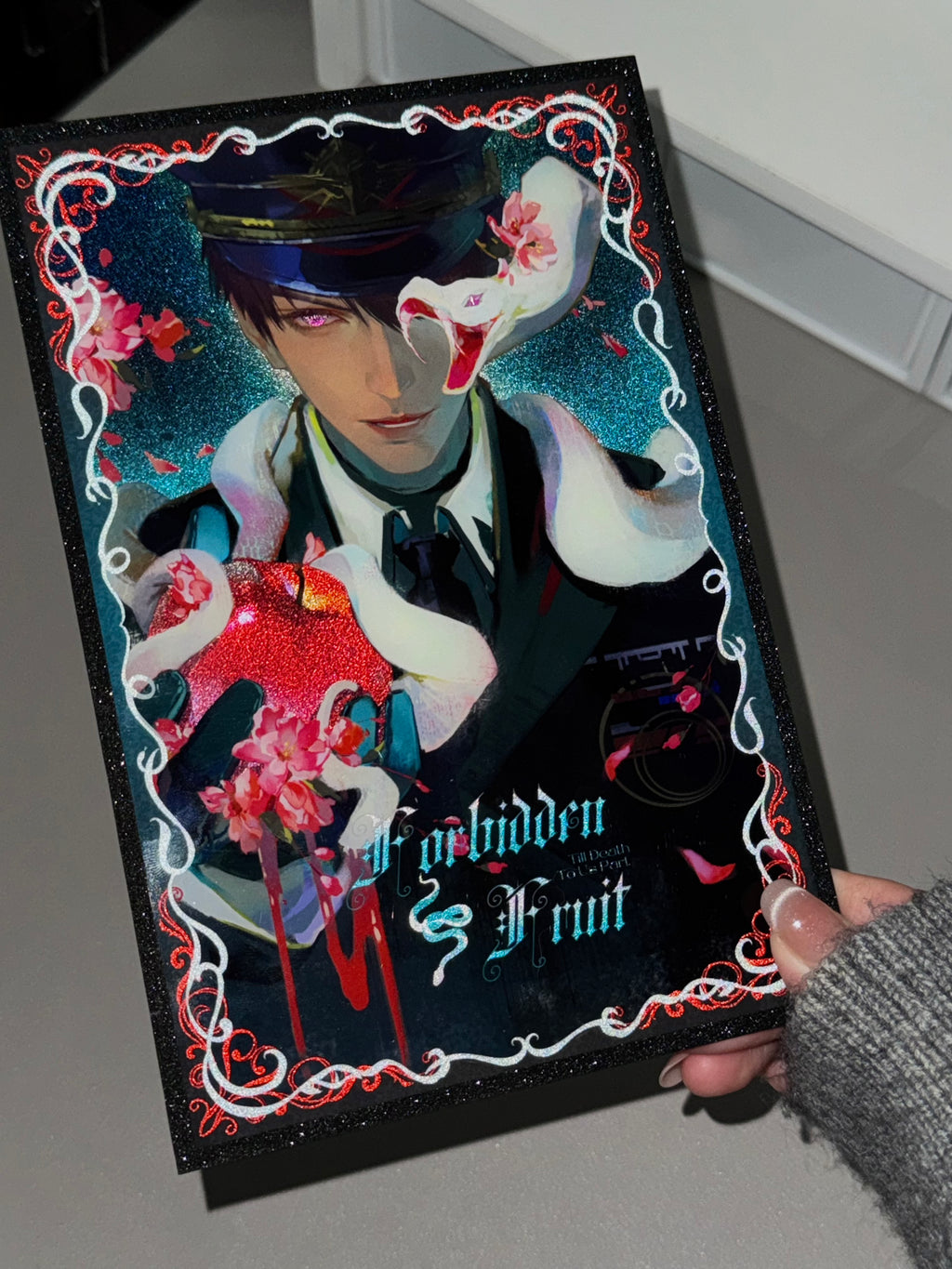 Physical display of Caleb Forbidden Apple acrylic shikishi board showing the acrylic finish by AO Treehouse.