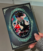 Physical display of Caleb Forbidden Apple oval button badge with matching backing card by AO Treehouse.