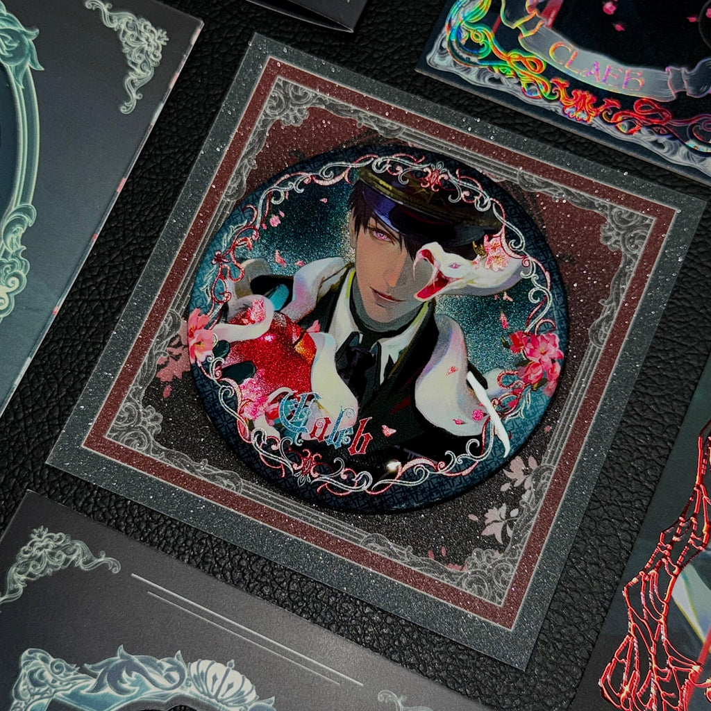 Detail view of Caleb Forbidden Apple button badge with dark gothic serpent artwork by AO Treehouse.
